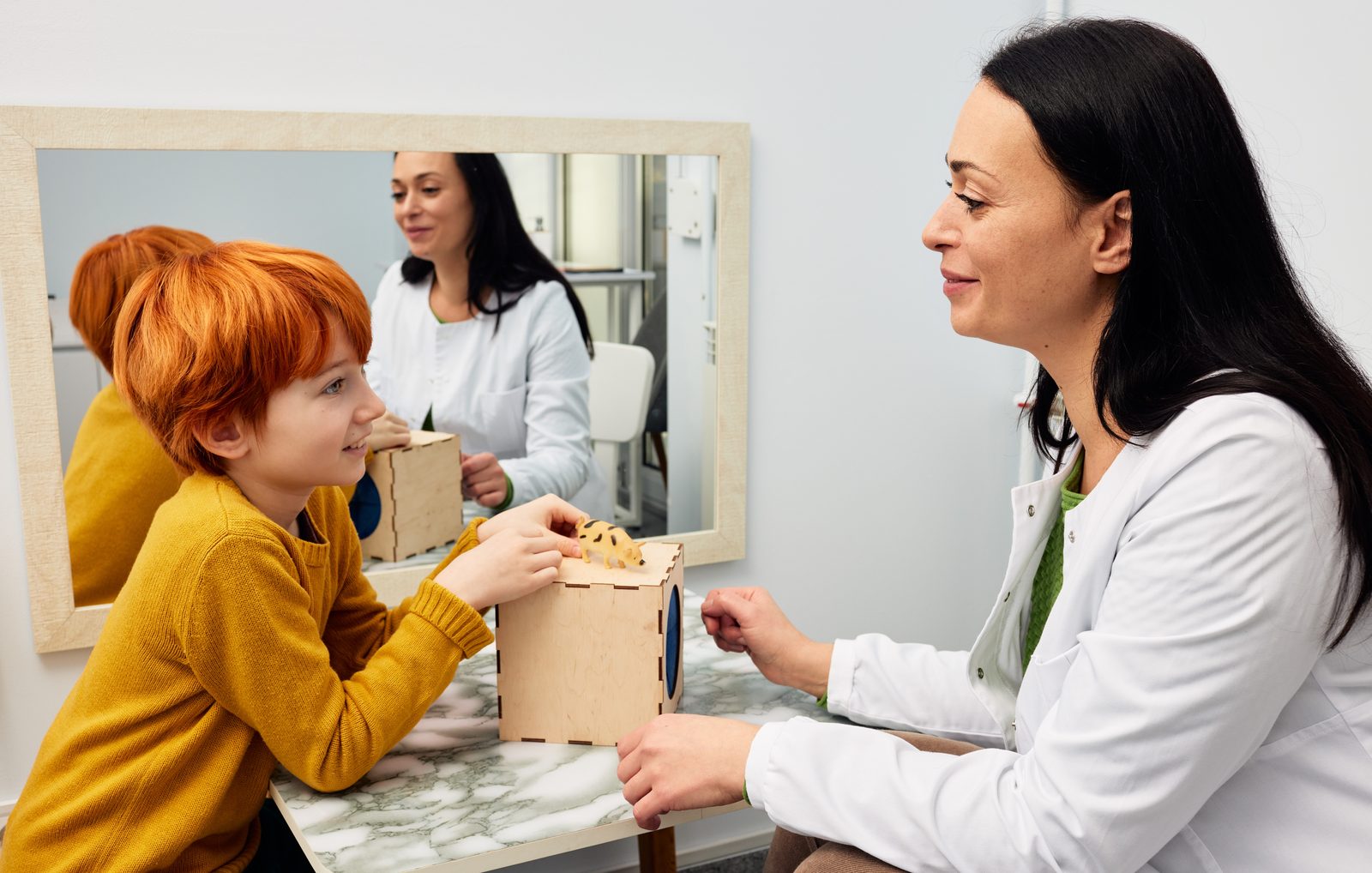 A behavior technician working one-on-one with a child during a session